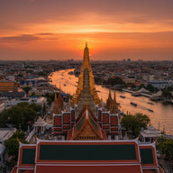 Bangkok Wall Art canvas print, a golden temple spire and steep tiled roofs catching sunset light with the river and long
