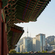 Seoul Wall Art canvas print, a traditional palace gate with painted eaves in the foreground and the modern city skyline