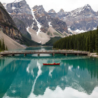 Lake Emerald Wall Art canvas print, Emerald Lake in the Canadian Rockies, vivid green glacial water with a red wooden canoe
