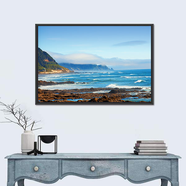 Rocky Shoreline with Crashing Waves and Misty Coastal Hills Canvas Wall Art