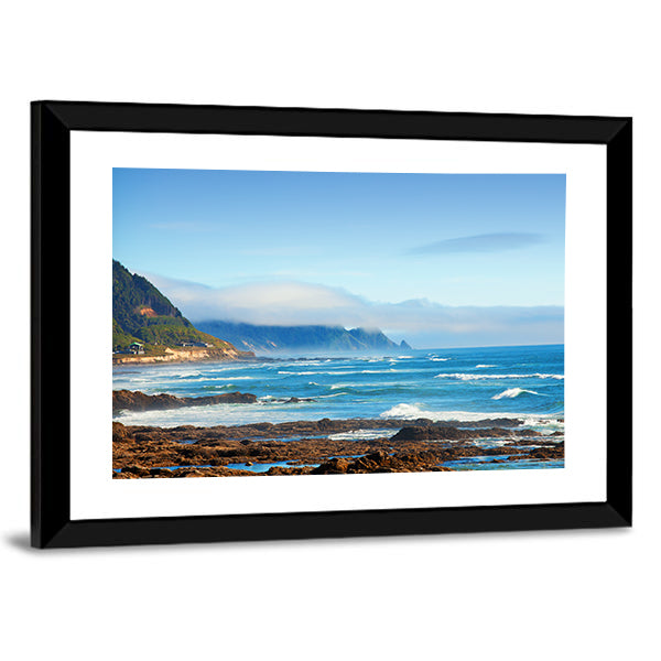 Rocky Shoreline with Crashing Waves and Misty Coastal Hills Canvas Wall Art
