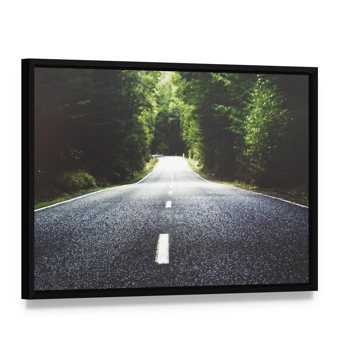 Summer Country Road Through Forest Canvas Wall Art, framed canvas in a black floater frame, angled product view