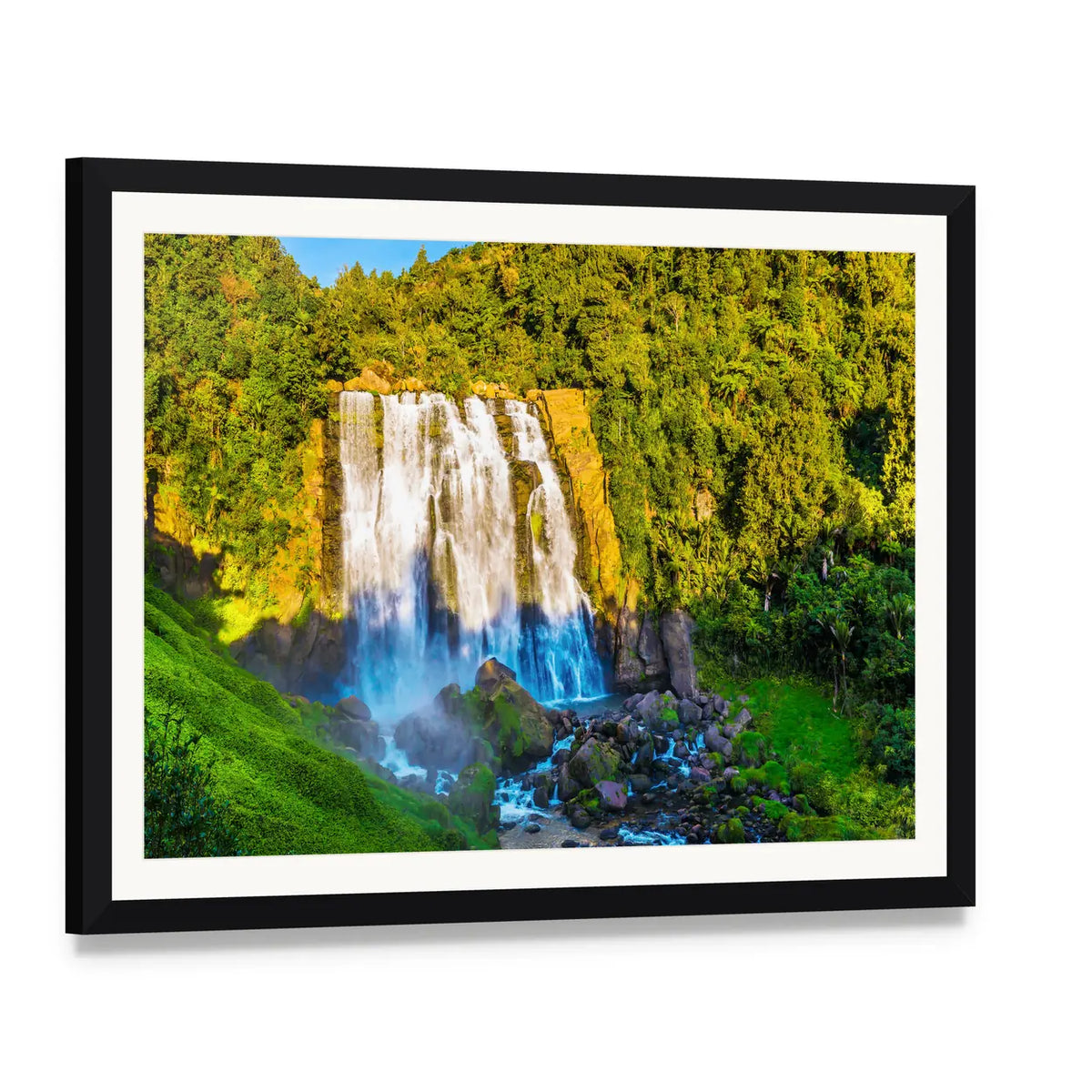Marokopa Falls Over Forested Rocks Canvas Wall Art, framed print with white mat and black frame, angled product view