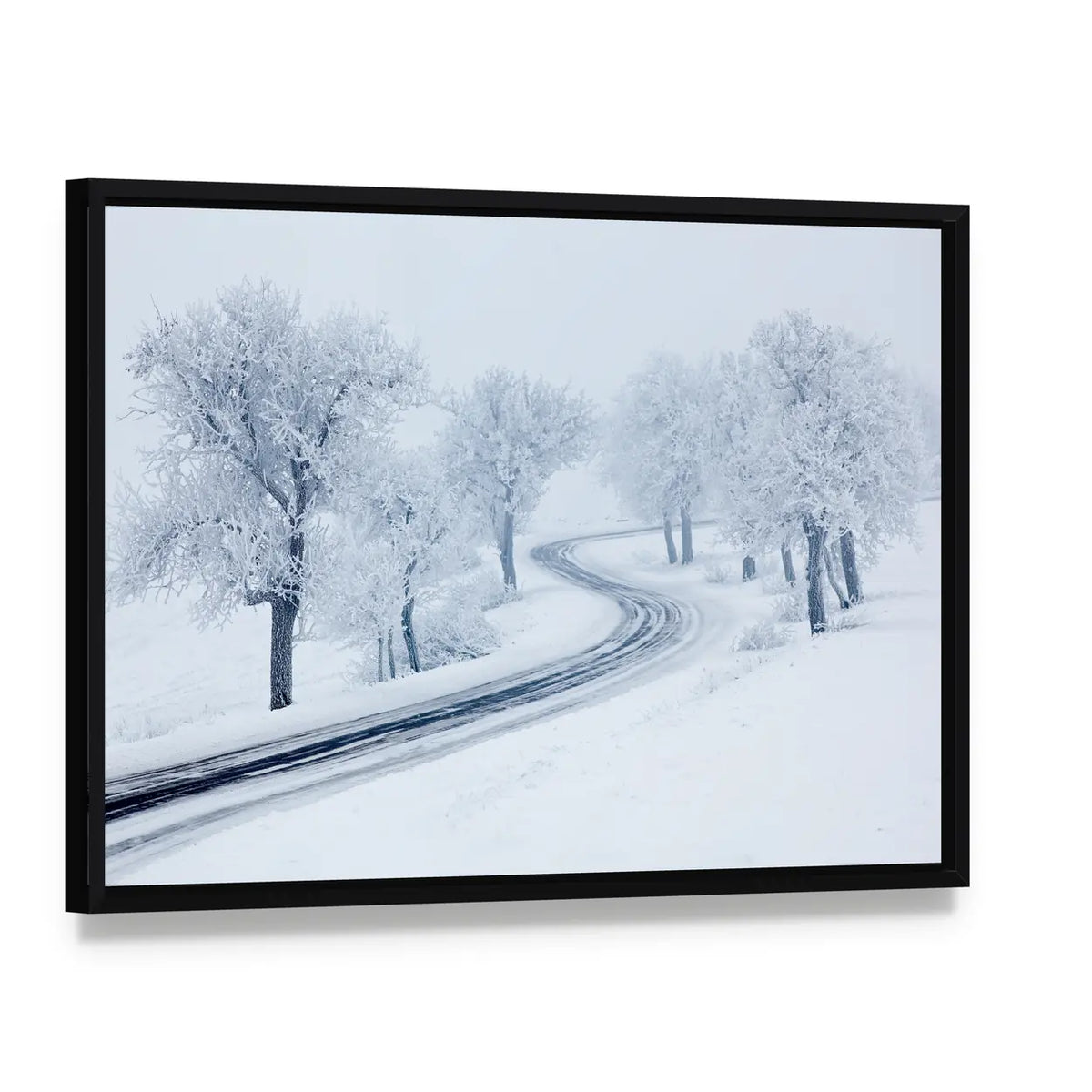 Snowy Winter Road Canvas Wall Art, framed canvas in a black floater frame, angled product view