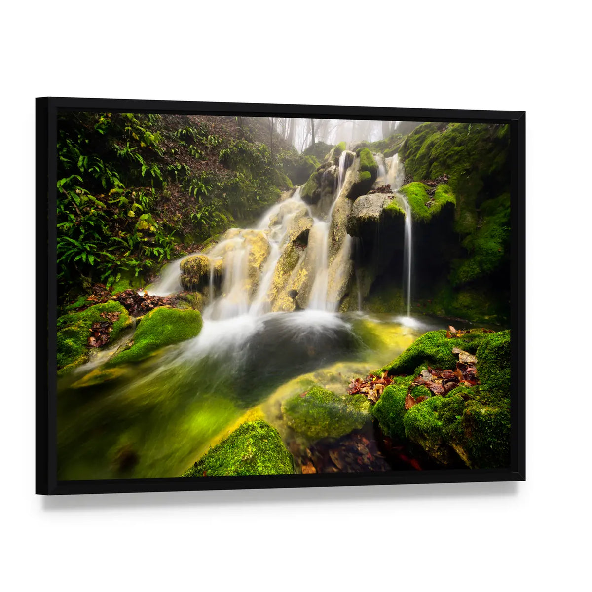 Forest Waterfall with Moss-covered Rocks Canvas Wall Art, framed canvas in a black floater frame, angled product view