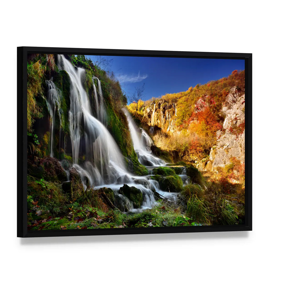 Autumn Waterfall with Mossy Rocks Canvas Wall Art, framed canvas in a black floater frame, angled product view