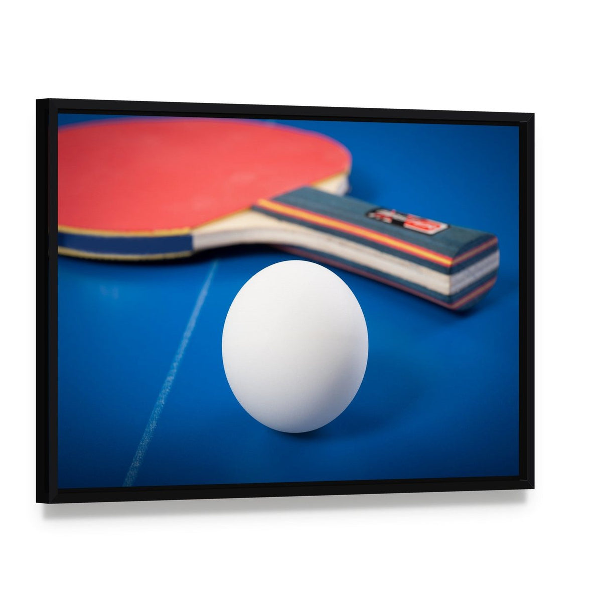 Table Tennis Ball and Racket Canvas Wall Art, framed canvas in a black floater frame, angled product view