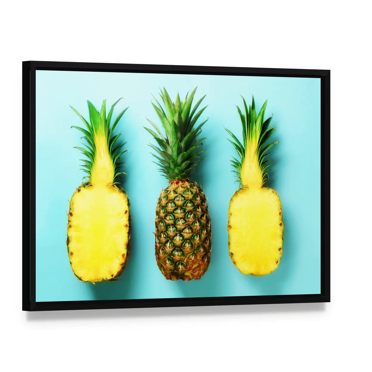 Three Pineapples in a Row Canvas Wall Art, framed canvas in a black floater frame, angled product view