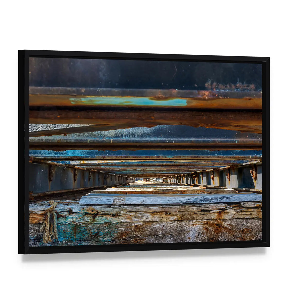 Under Pier Rusted Beams and Weathered Wood Canvas Wall Art, framed canvas in a black floater frame, angled product view