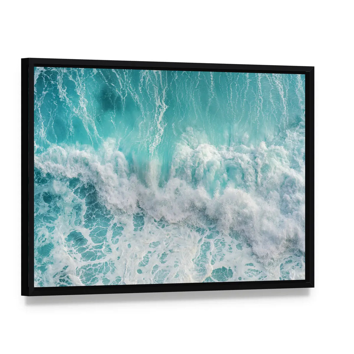 Aerial View Of The Ocean Wave Canvas Wall Art, framed canvas in a black floater frame, angled product view