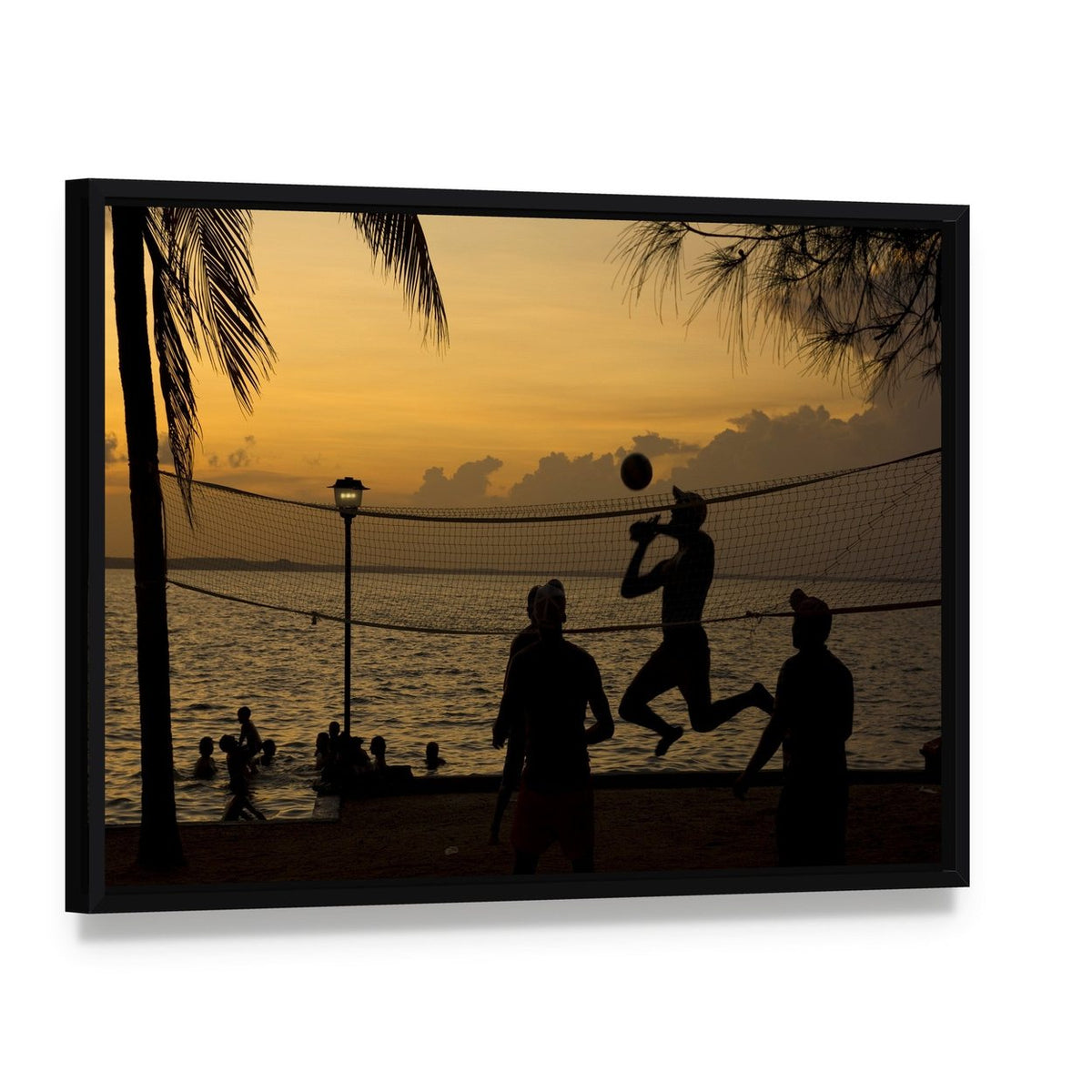 Silhouette of People Playing Beach Volleyball at Sunset Canvas Wall Art, framed canvas in a black floater frame, angled product view