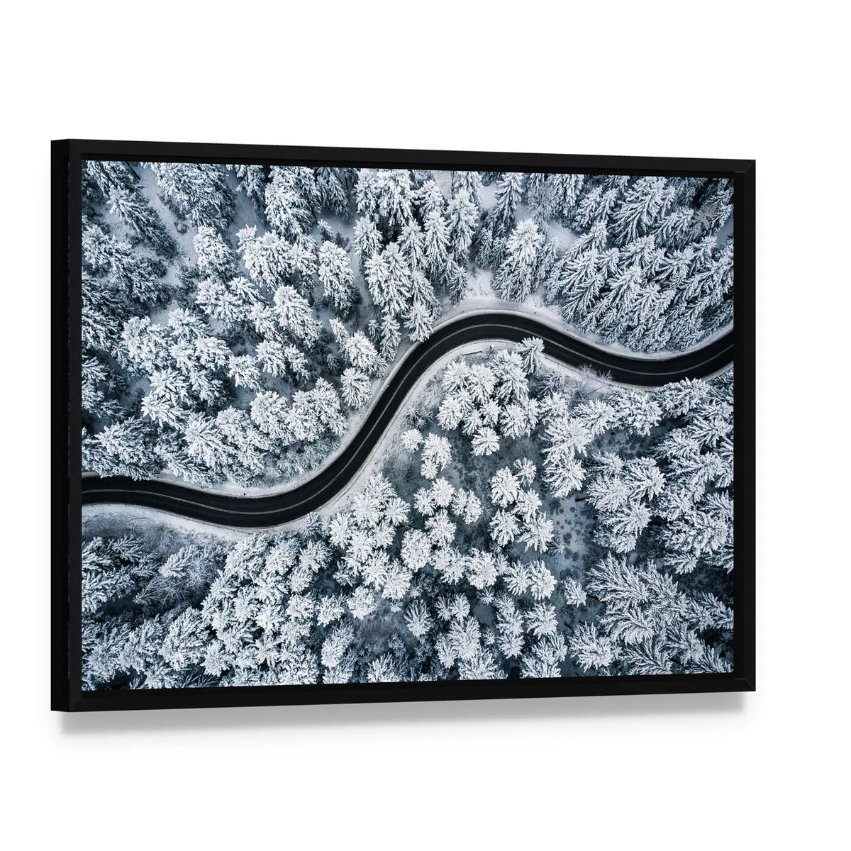 Curvy Windy Road In Snow Covered Forest Canvas Wall Art, framed canvas in a black floater frame, angled product view