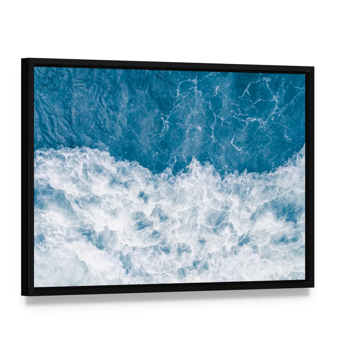 Pale Blue Sea Wave Canvas Wall Art, framed canvas in a black floater frame, angled product view