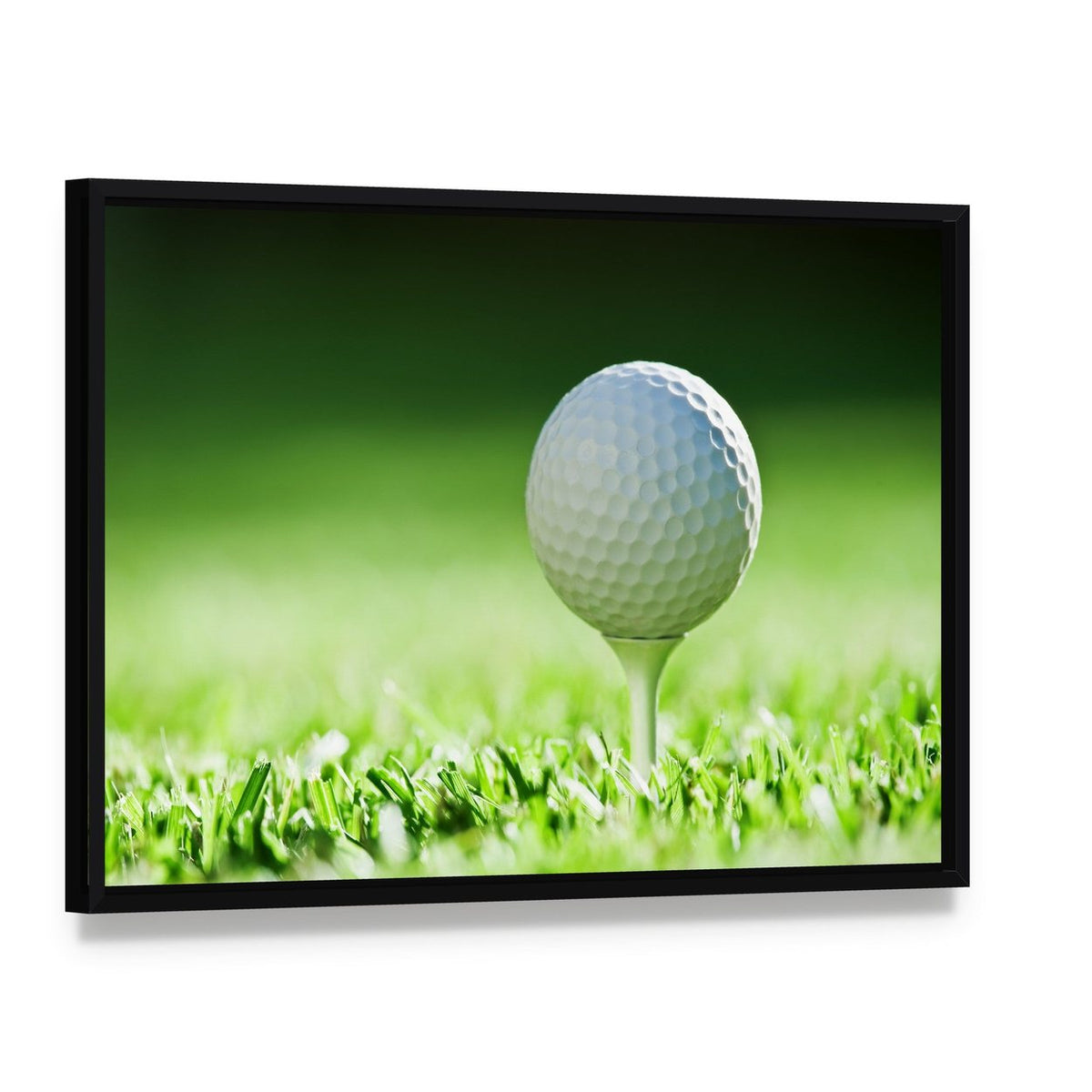 Golf Ball on Green Grass Canvas Wall Art, framed canvas in a black floater frame, angled product view