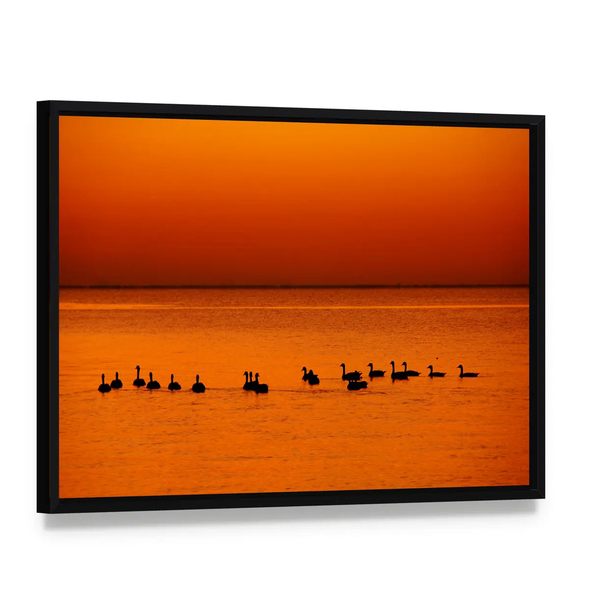 Family of Geese at Sunset Canvas Wall Art, framed canvas in a black floater frame, angled product view