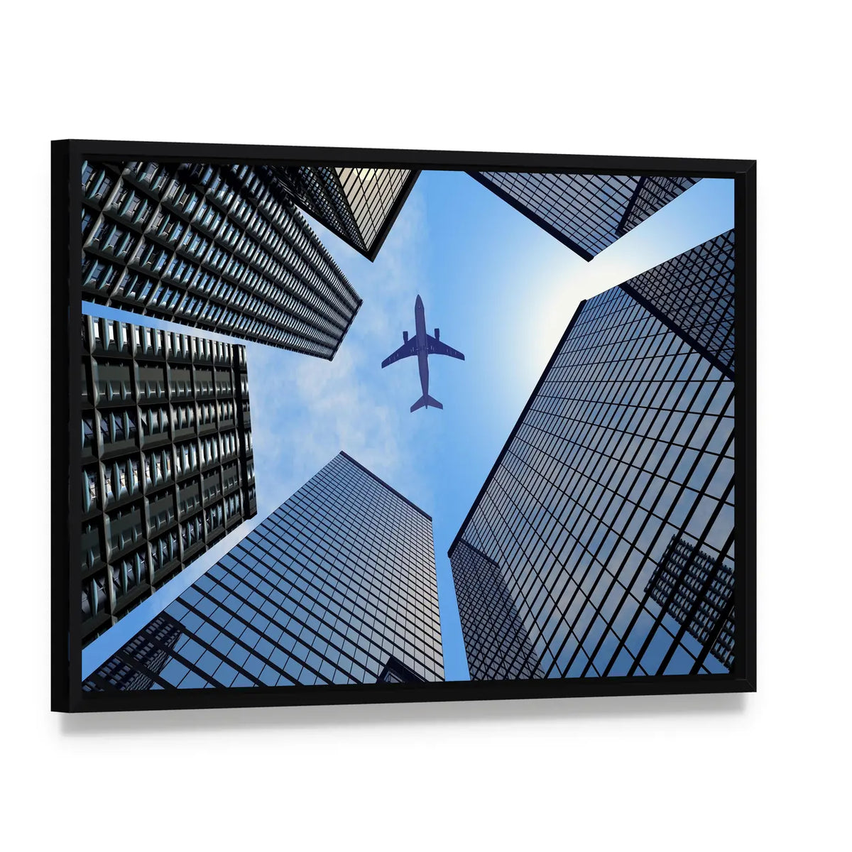 Airplane Above Skyscrapers Canvas Wall Art, framed canvas in a black floater frame, angled product view