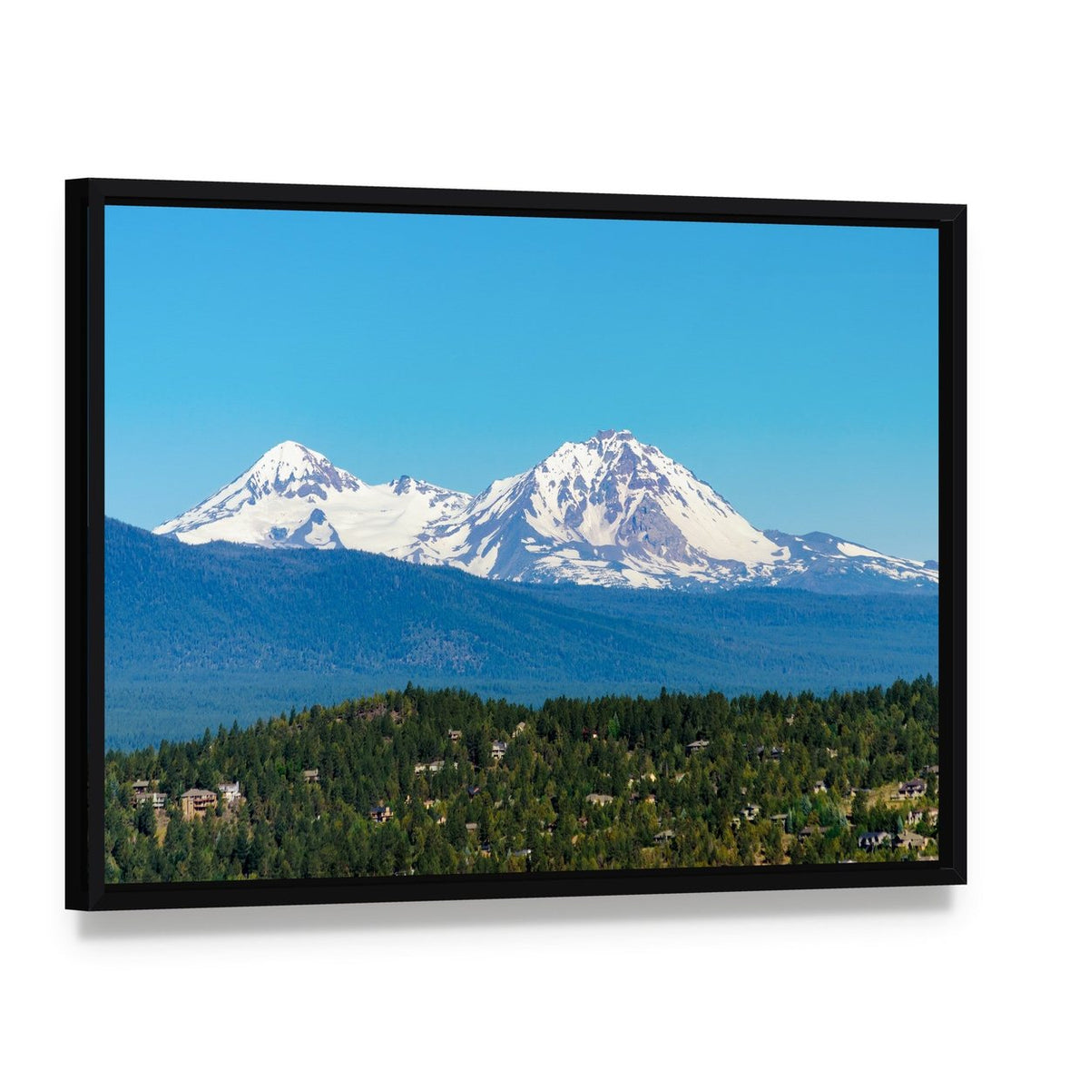 Snow Covered Three Sisters Mountains Canvas Wall Art, framed canvas in a black floater frame, angled product view