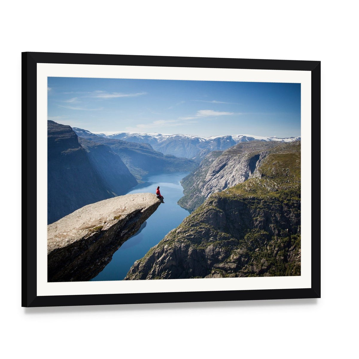 Person on Trolltunga During Daytime Canvas Wall Art, framed print with white mat and black frame, angled product view