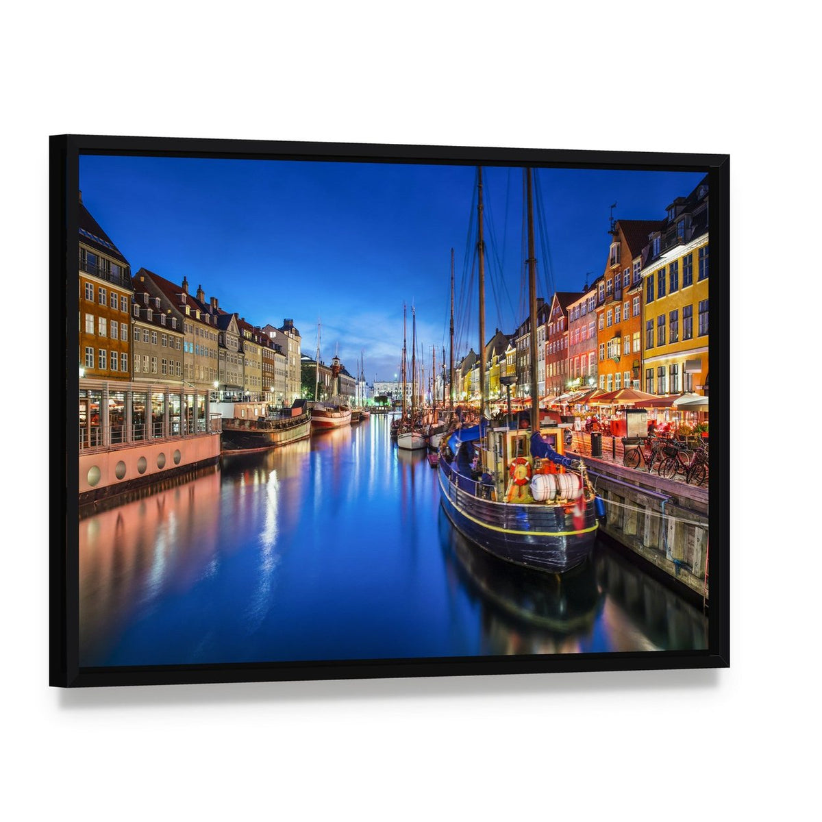 Vibrant Nyhavn Canal Scene at Night Canvas Wall Art, framed canvas in a black floater frame, angled product view