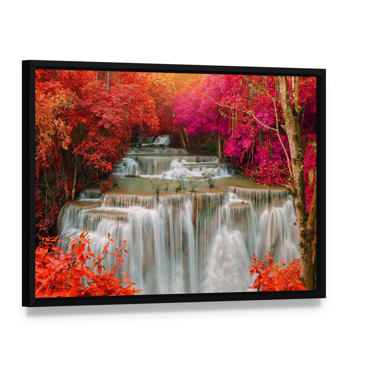 Waterfall in Pink and Red Trees Canvas Wall Art, framed canvas in a black floater frame, angled product view