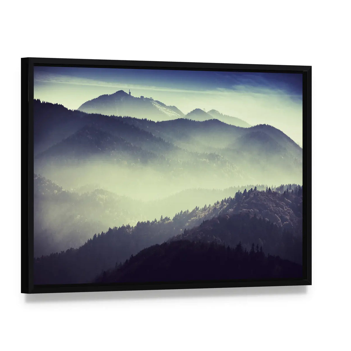 Misty Mountain Valley with Tower Silhouette Canvas Wall Art, framed canvas in a black floater frame, angled product view