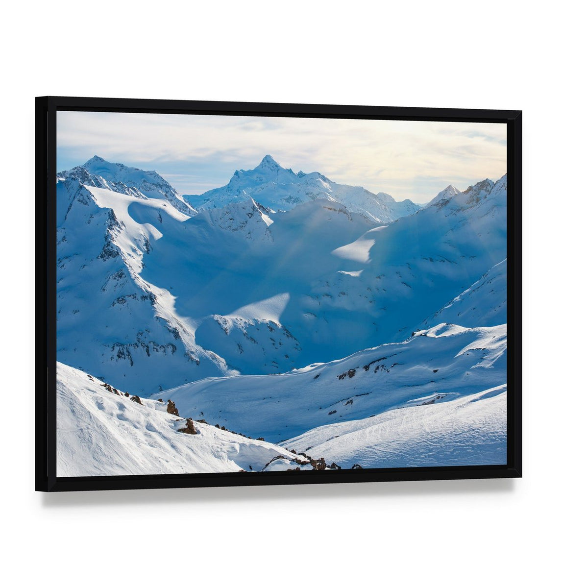 Snowy Blue Mountains in Clouds Canvas Wall Art, framed canvas in a black floater frame, angled product view