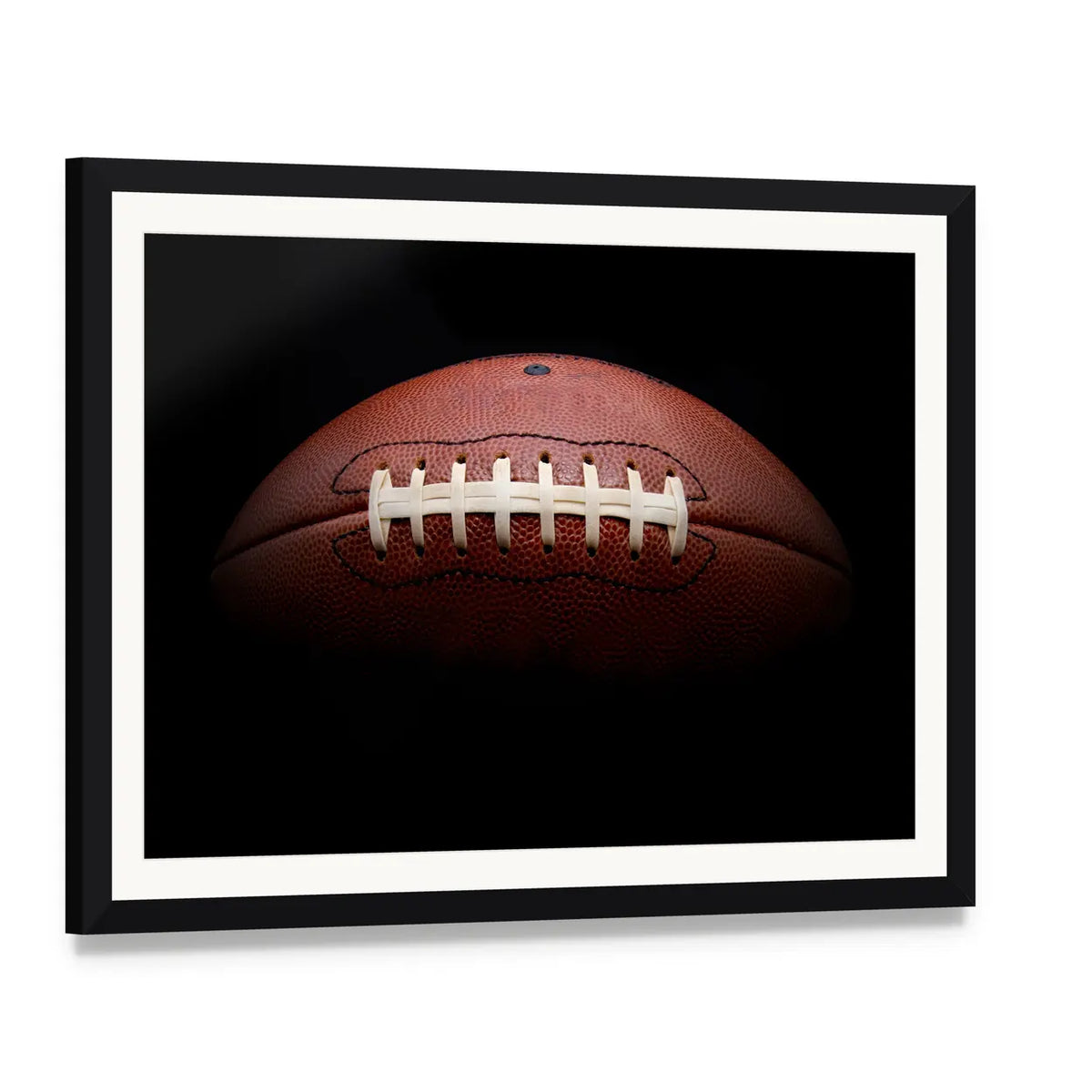American Football Close-up with White Laces Canvas Wall Art, framed print with white mat and black frame, angled product view