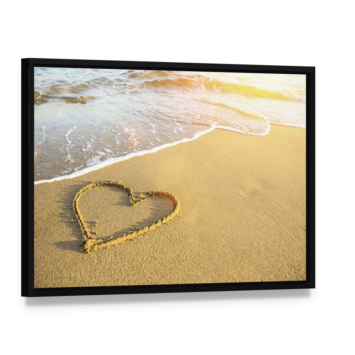 Heart Drawn on Sand Canvas Wall Art, framed canvas in a black floater frame, angled product view