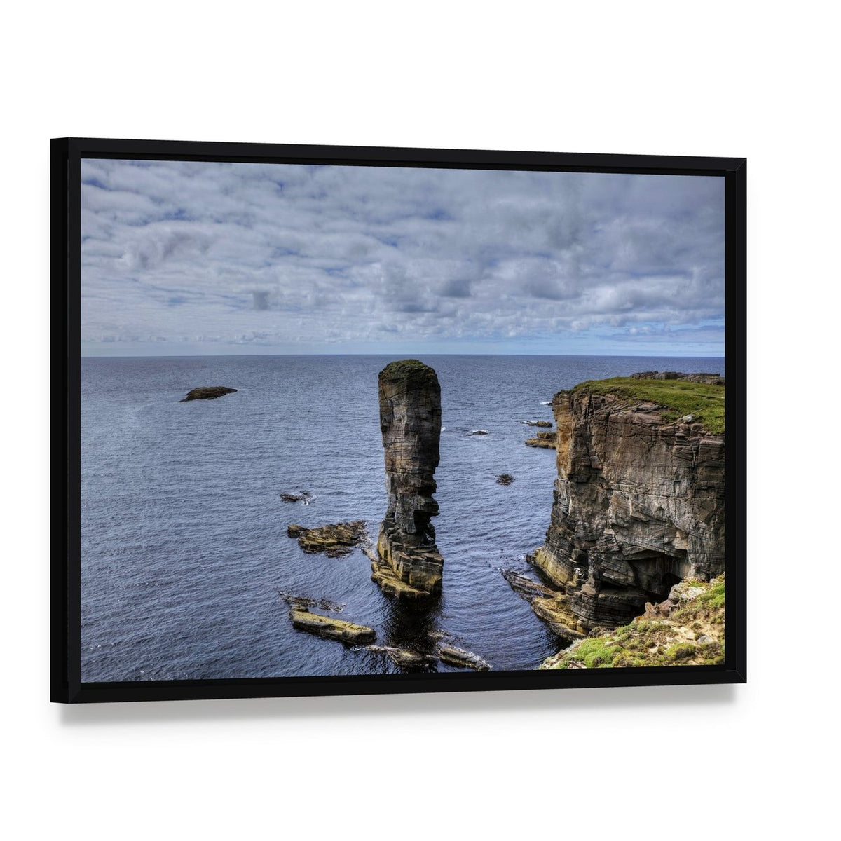 Yesnaby Castle Canvas Wall Art, framed canvas in a black floater frame, angled product view