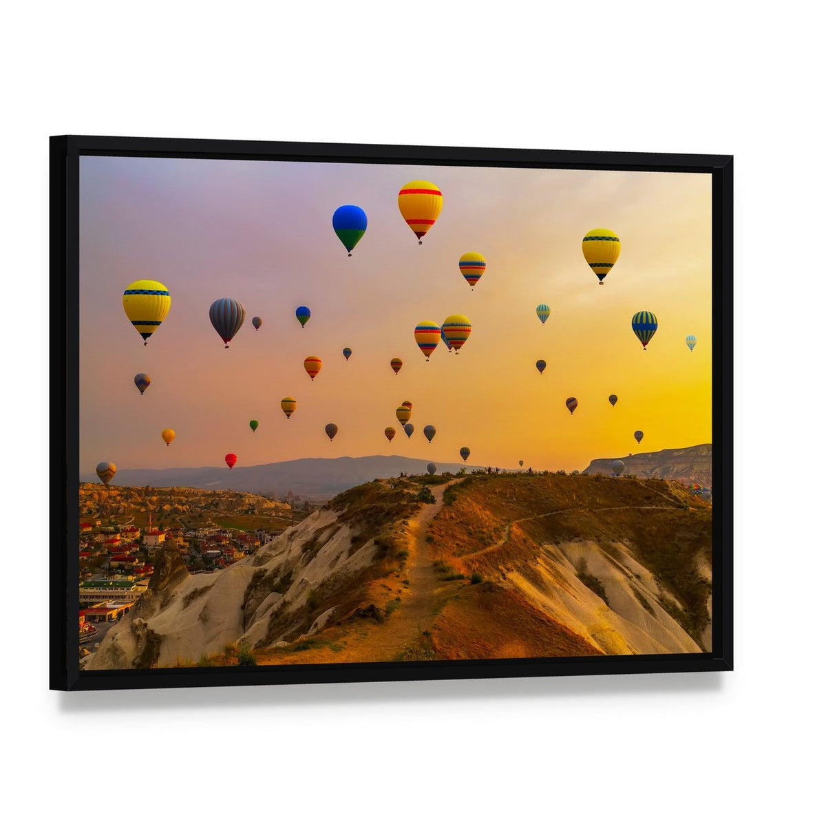 Hot Air Balloons Over a Vast Valley Canvas Wall Art, framed canvas in a black floater frame, angled product view