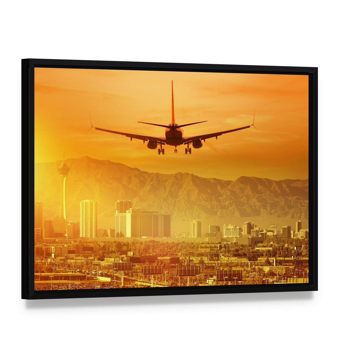 Airplane Flying Above City Canvas Wall Art, framed canvas in a black floater frame, angled product view