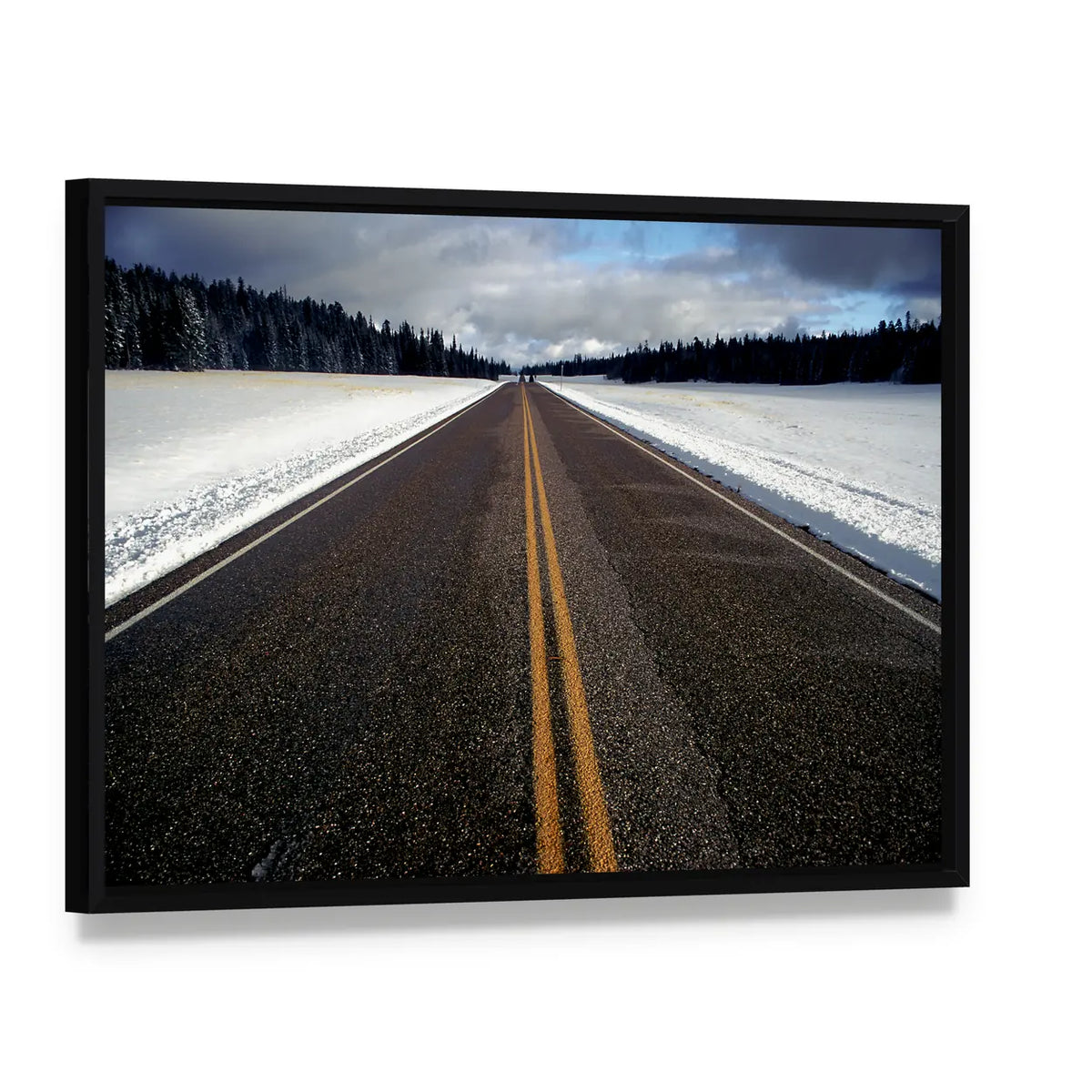 Winter Road with Double Yellow Lines Canvas Wall Art, framed canvas in a black floater frame, angled product view