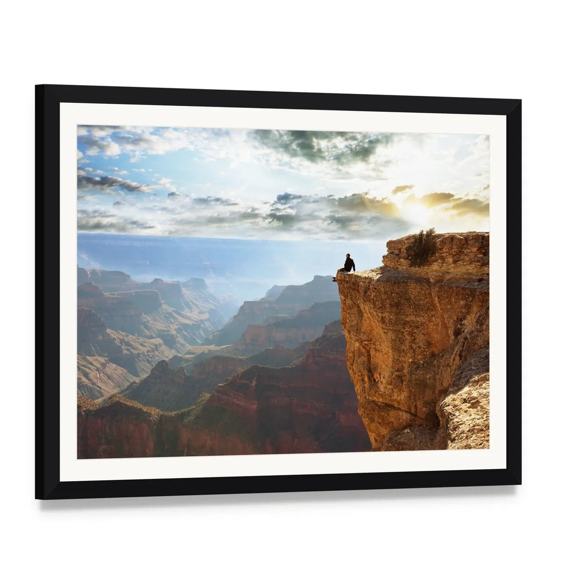 Man Sitting on Grand Canyon Canvas Wall Art, framed print with white mat and black frame, angled product view