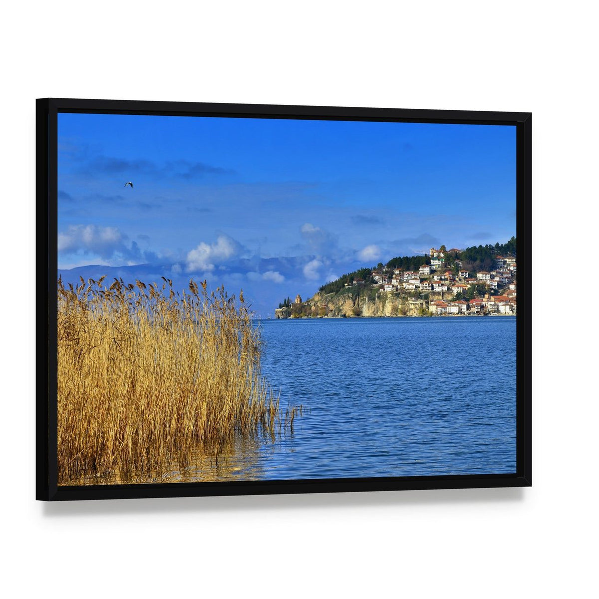 Lake Ohrid Reeds and Mountain Town Canvas Wall Art, framed canvas in a black floater frame, angled product view