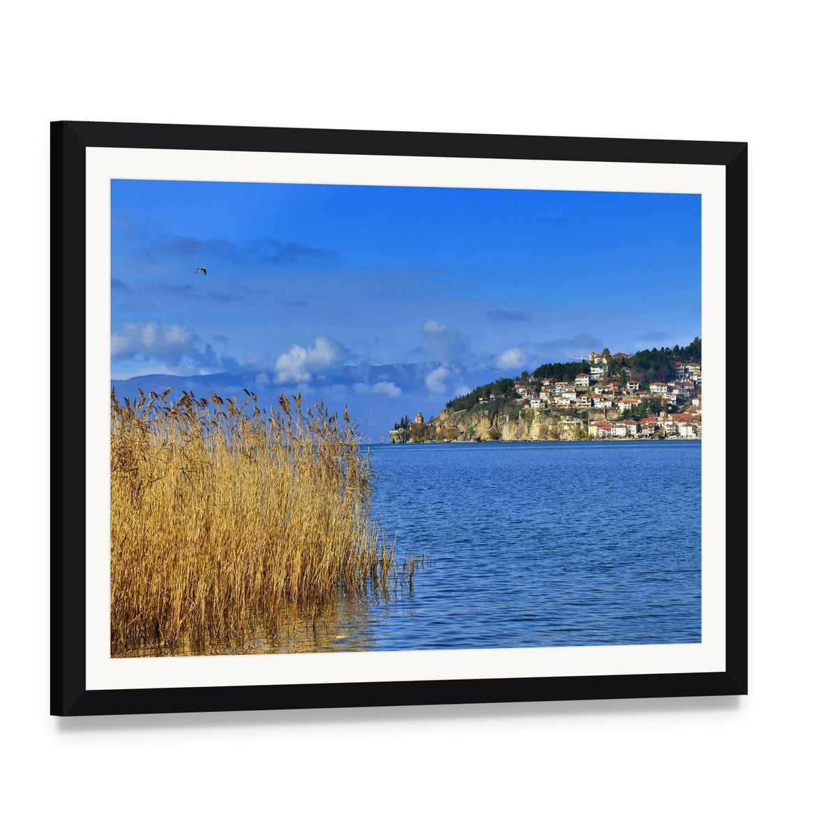 Lake Ohrid Reeds and Mountain Town Canvas Wall Art, framed print with white mat and black frame, angled product view