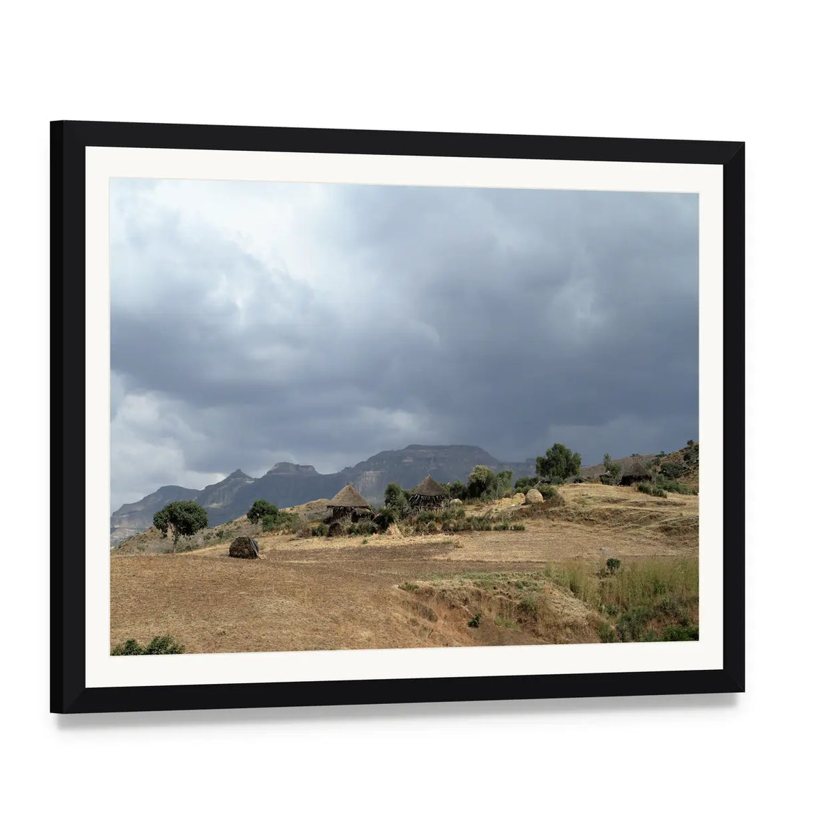 Thatched Huts in Rural Africa Canvas Wall Art, framed print with white mat and black frame, angled product view