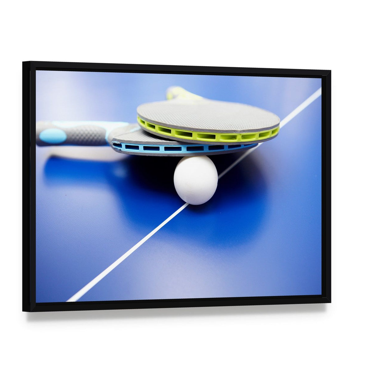 Table Tennis Rackets and Ball on Blue Table Canvas Wall Art, framed canvas in a black floater frame, angled product view