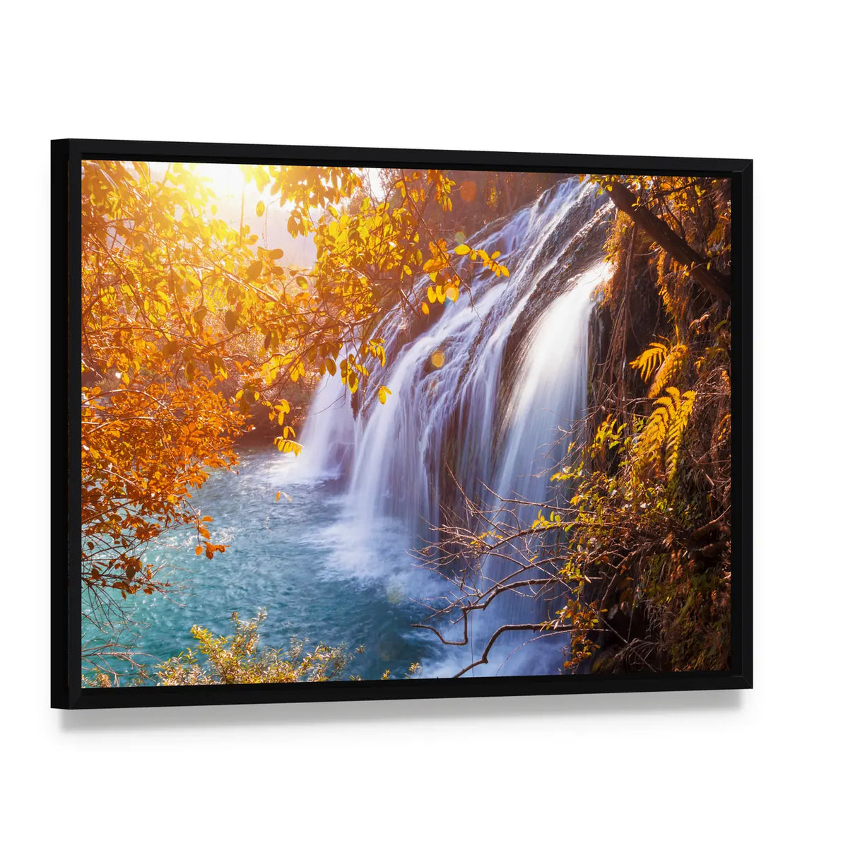 Autumn Waterfall with Sunlit Foliage Canvas Wall Art, framed canvas in a black floater frame, angled product view