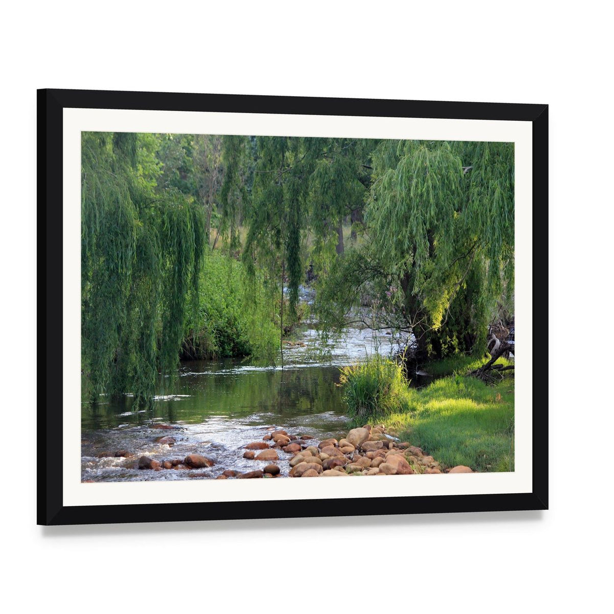 River Flowing Past Willow Trees Canvas Wall Art, framed print with white mat and black frame, angled product view
