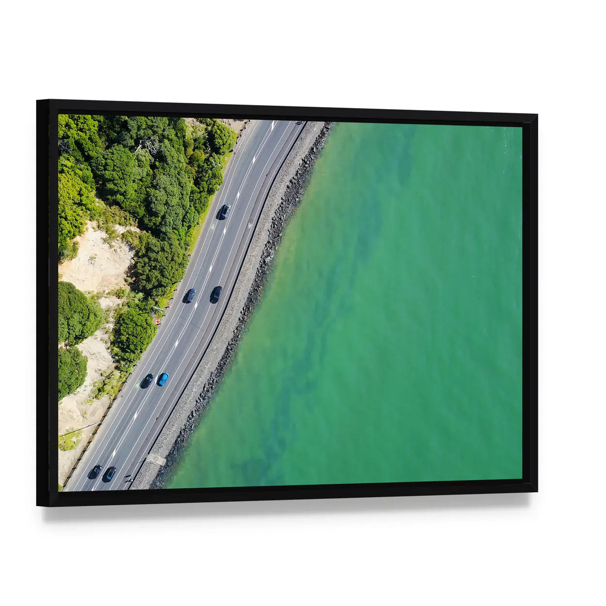 Coastal Road in Auckland Canvas Wall Art, framed canvas in a black floater frame, angled product view