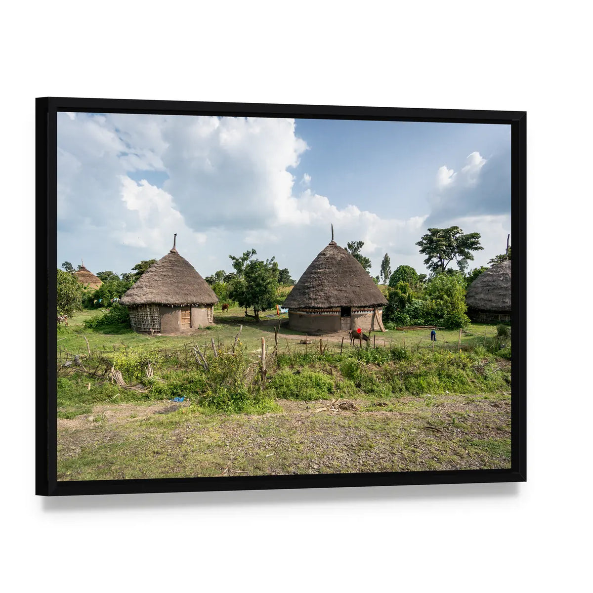 Omo Valley Straw Huts Canvas Wall Art, framed canvas in a black floater frame, angled product view