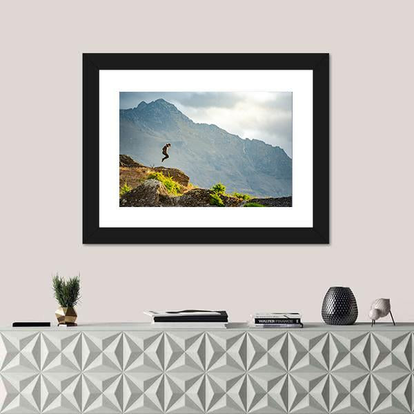 Young Man Jumping On Queenstown Hill Canvas Wall Art-1 Piece-Framed Print-20" x 16"-Tiaracle