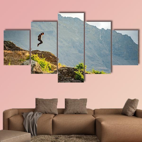 Young Man Jumping On Queenstown Hill Canvas Wall Art-5 Star-Gallery Wrap-62" x 32"-Tiaracle