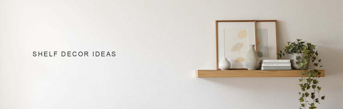 Shelf decor ideas: a pale oak floating shelf styled with a leaning canvas print, ceramics and a trailing plant