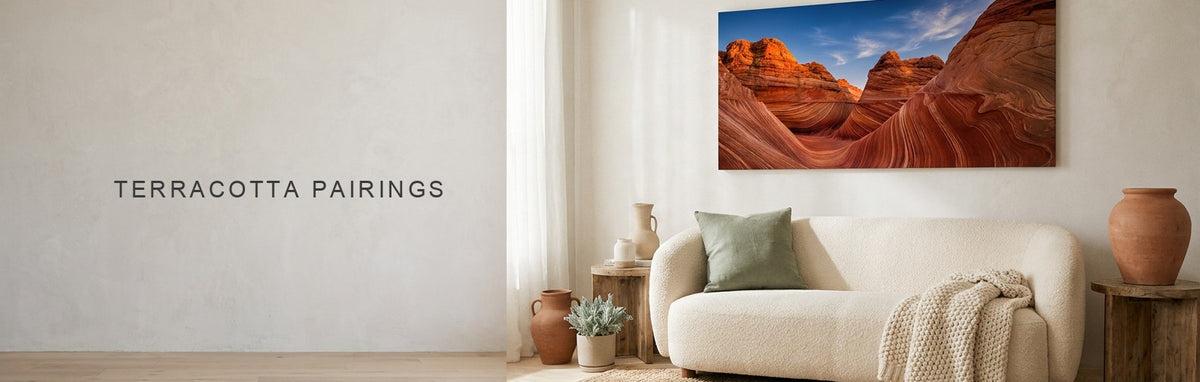 What colors go with terracotta, shown by a desert canyon canvas over a cream sofa