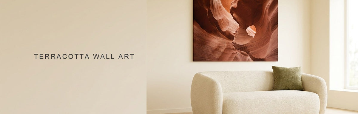 Terracotta wall art in a neutral living room with a rust canyon canvas