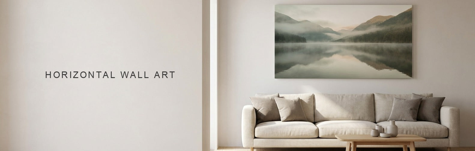 Horizontal wall art above a linen sofa, a wide misty mountain lake canvas