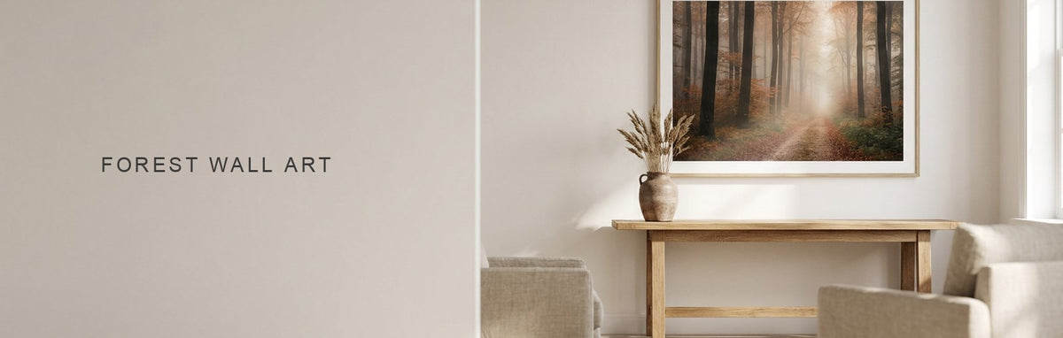 Forest wall art above a console, a misty path running away between tall trunks