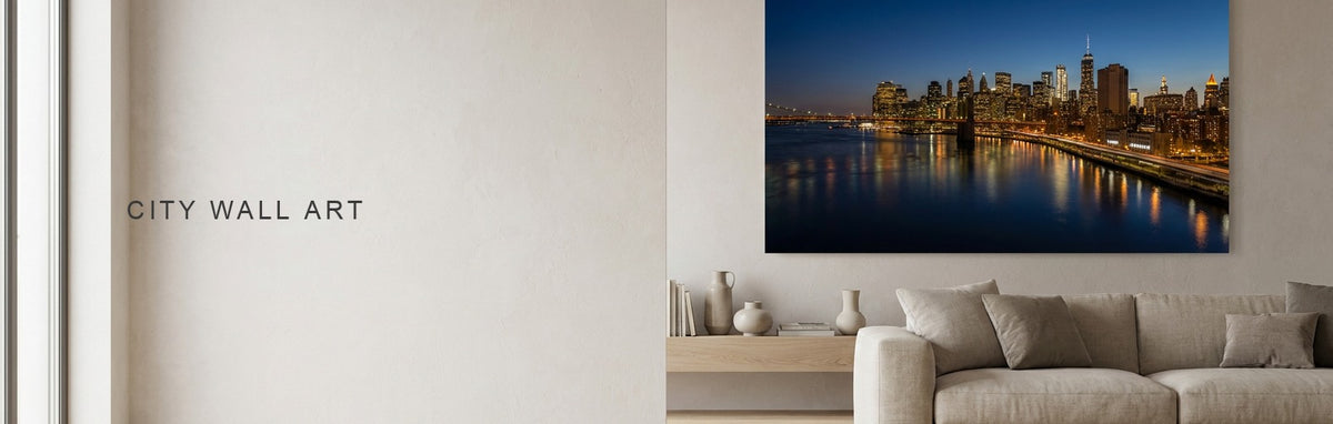 City wall art above a sofa, a lit skyline across water at night on canvas