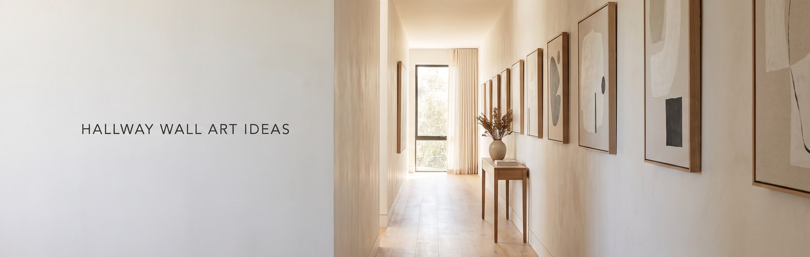 Hallway wall art ideas: framed canvas prints hung in an evenly spaced row along a bright narrow corridor